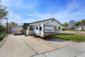 View of front facade featuring a garage and driveway