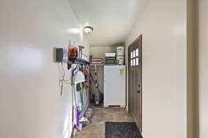 Entryway with water heater and stone finish flooring