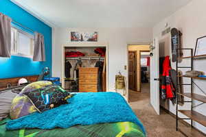Bedroom with carpet floors and a closet