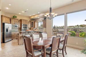 Dining space with hanging lights and light tile patterned floors