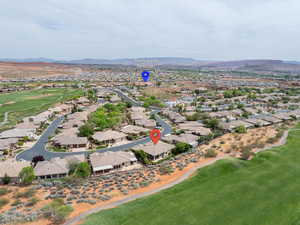 View of property location featuring a golf club and nearby suburban area