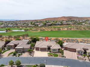 Aerial view of residential area featuring a golf course and a water and mountain view
