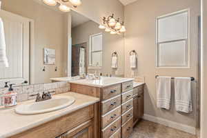 Full bathroom with vanity and a tile shower