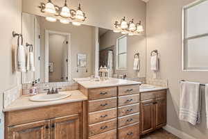 Bathroom featuring two vanities and a shower with curtain