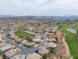 Aerial perspective of suburban area with mountains and a golf club