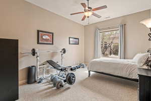 Bedroom featuring a ceiling fan and carpet flooring