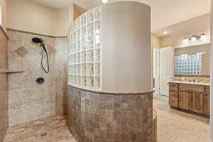 Bathroom featuring walk in shower and vanity