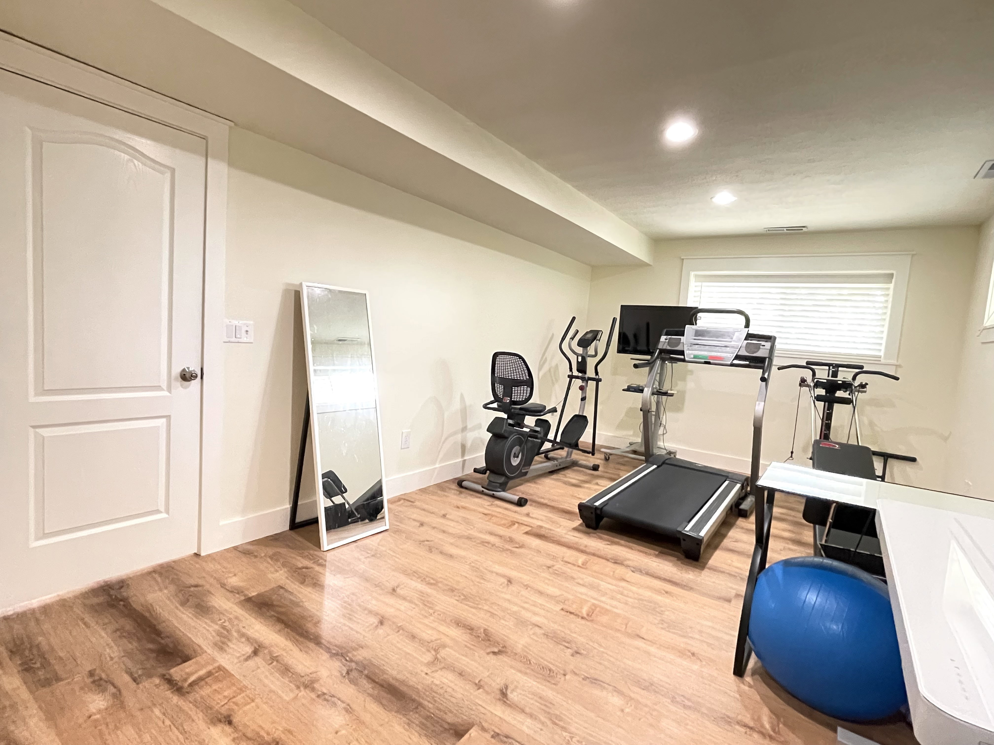Exercise area featuring wood finished floors and recessed lighting