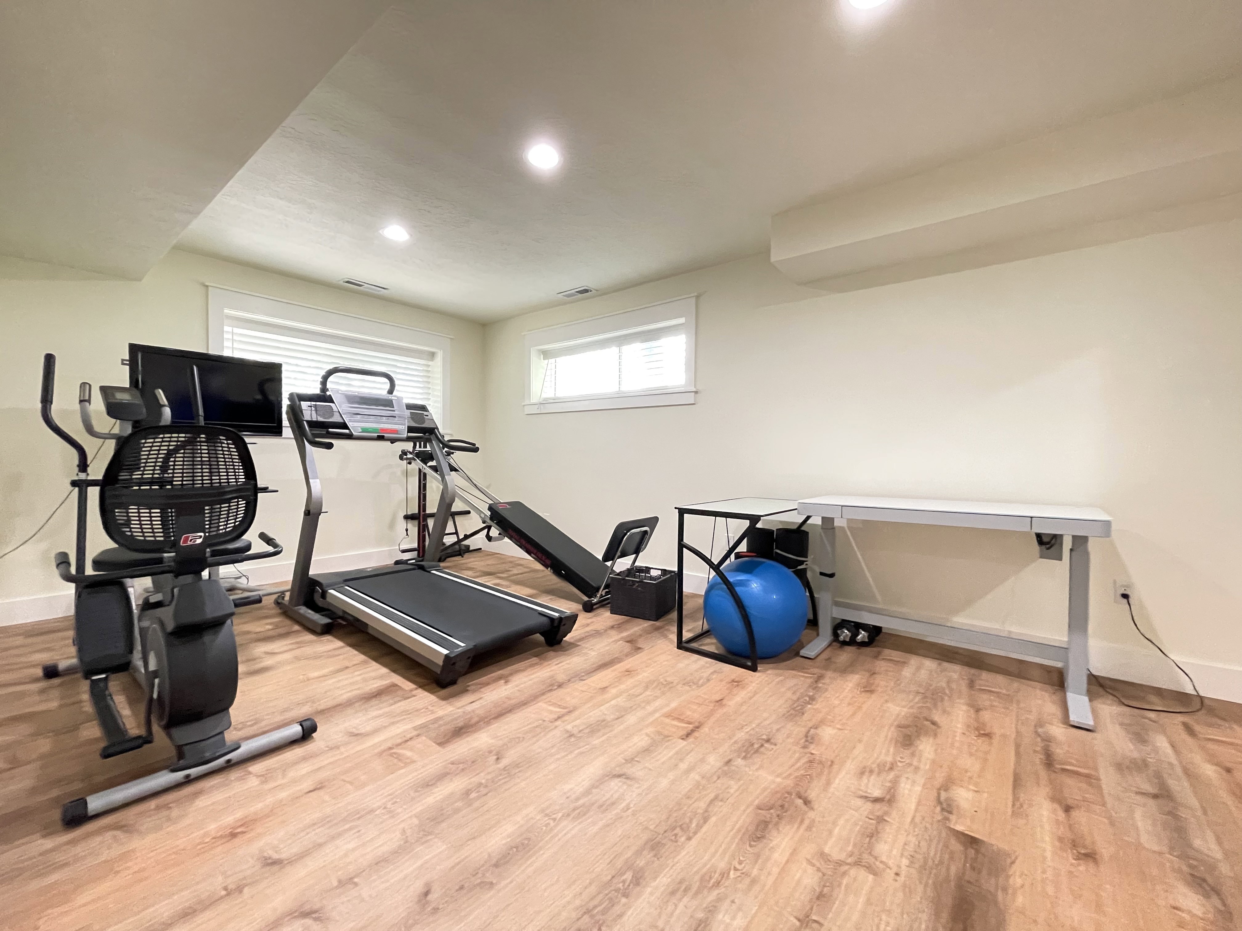 Workout area featuring light wood-style floors, plenty of natural light, and recessed lighting