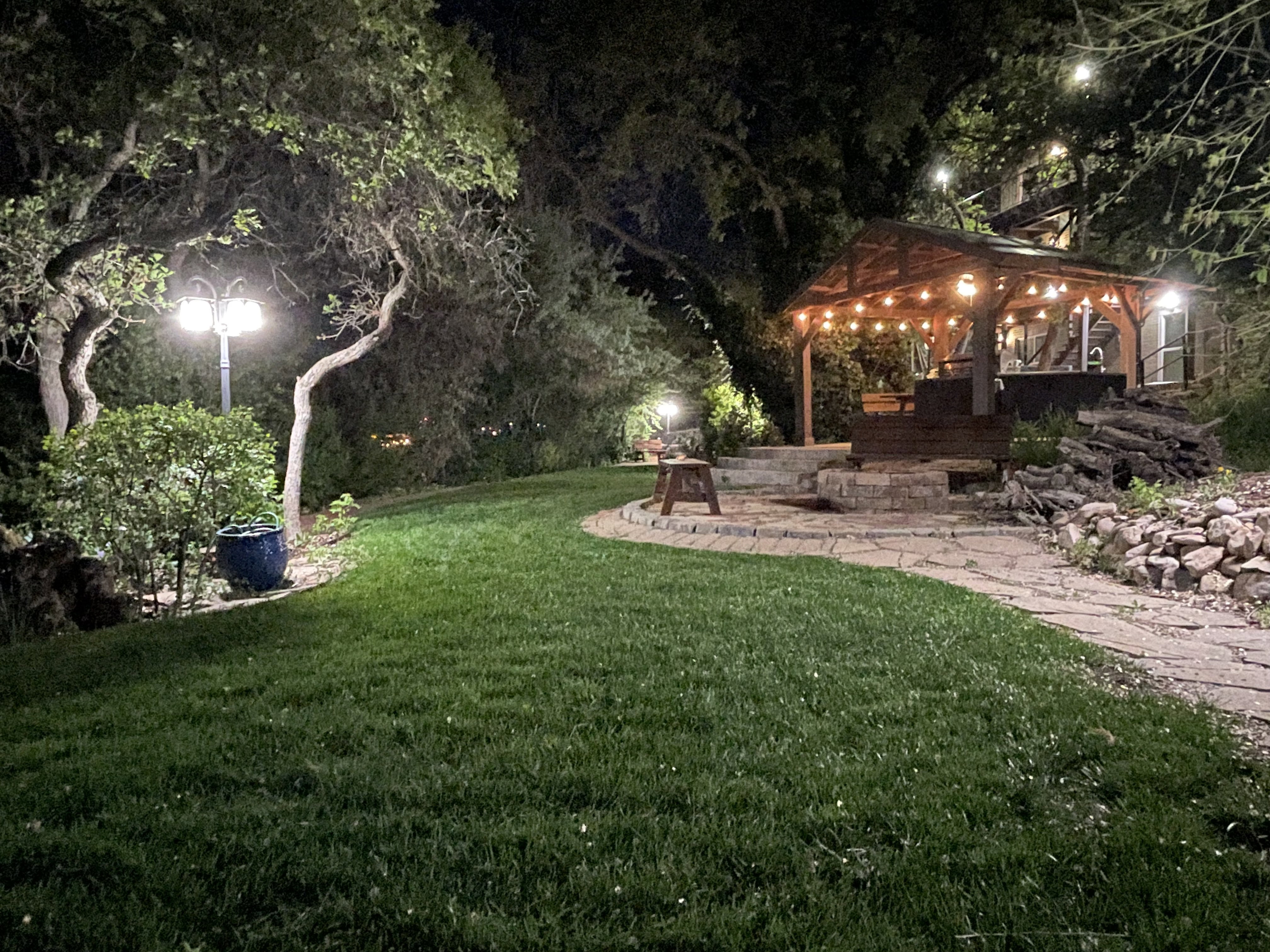 Yard at twilight featuring a lawn, a patio, and a gazebo