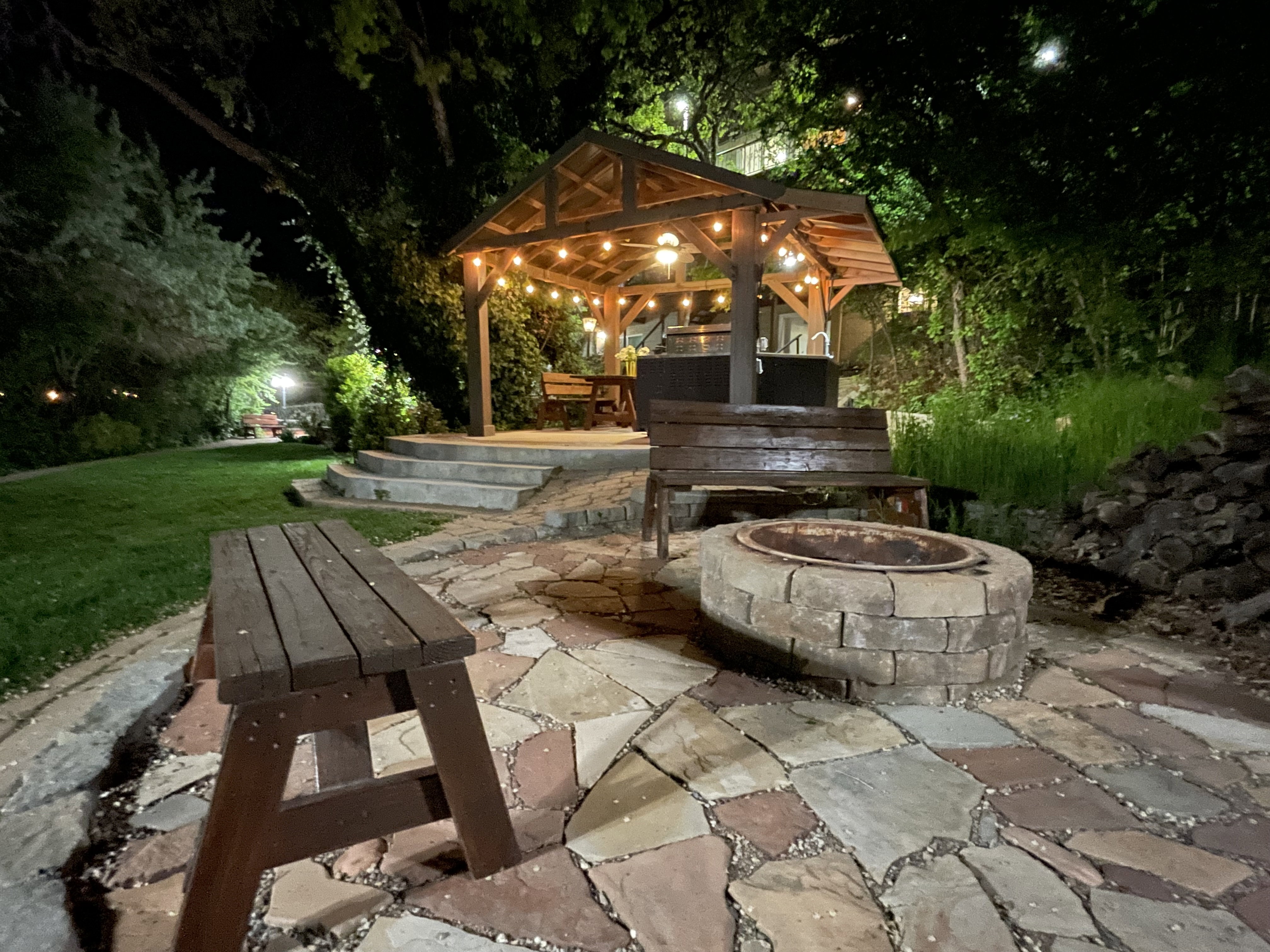 Patio at night featuring a patio, an outdoor fire pit, and a yard