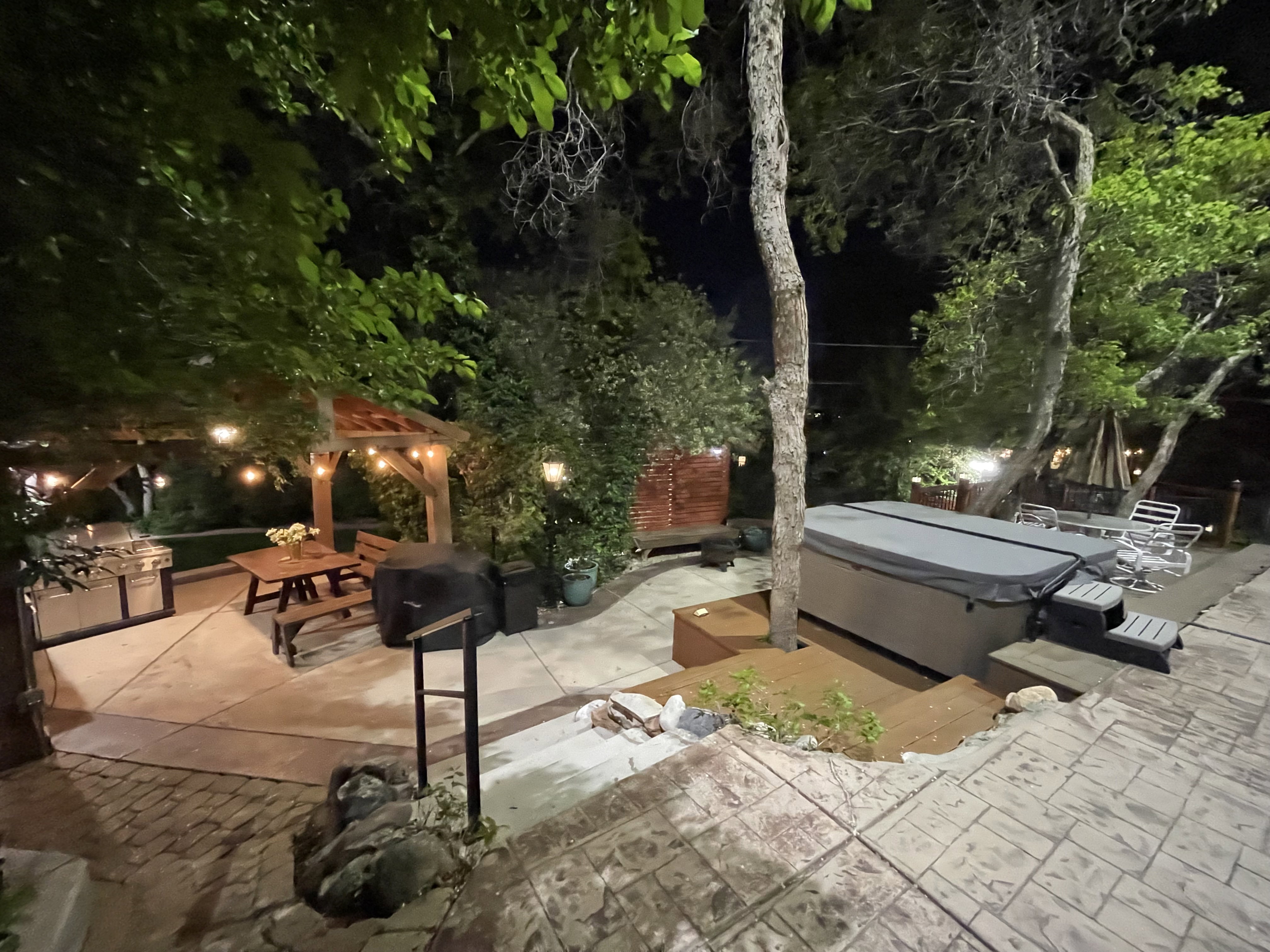 Patio at twilight featuring outdoor dining area, a hot tub, and a patio area