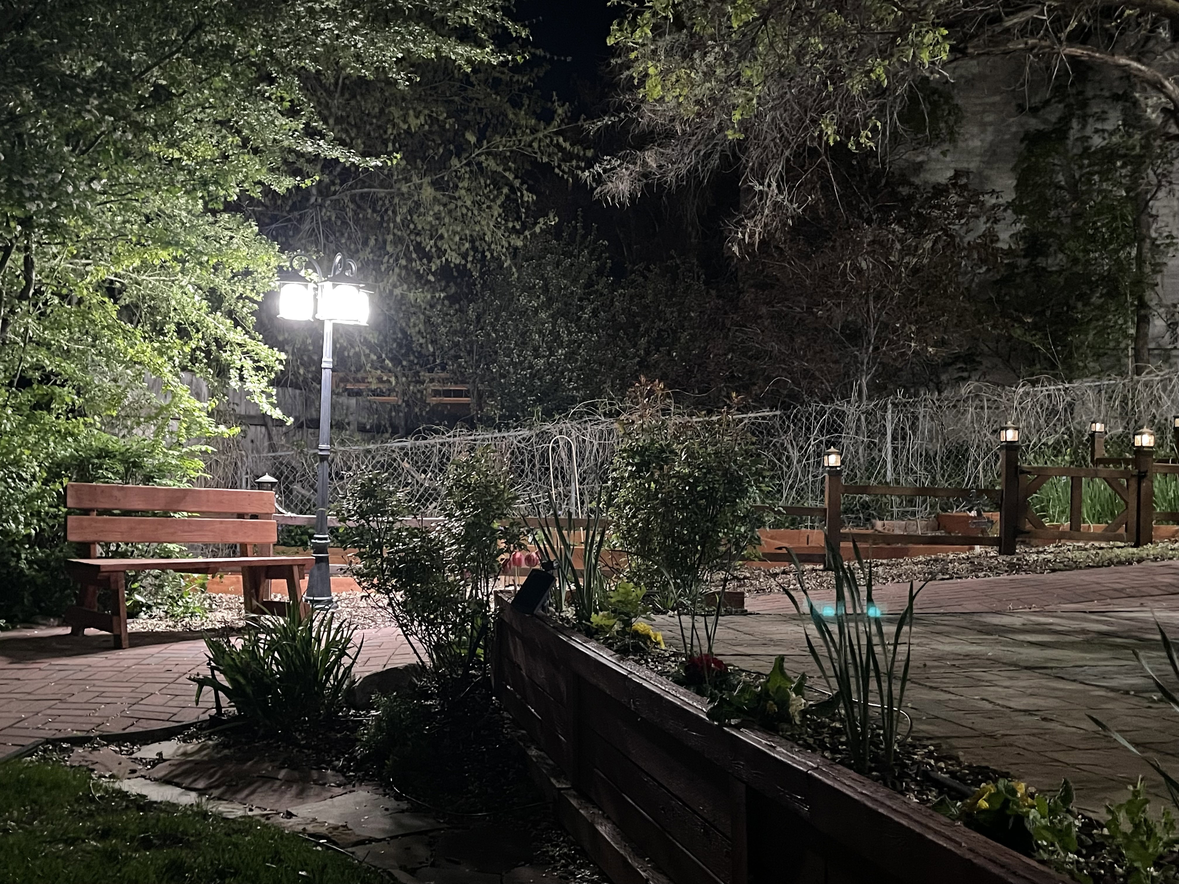 Patio at night with a patio area and a fenced backyard