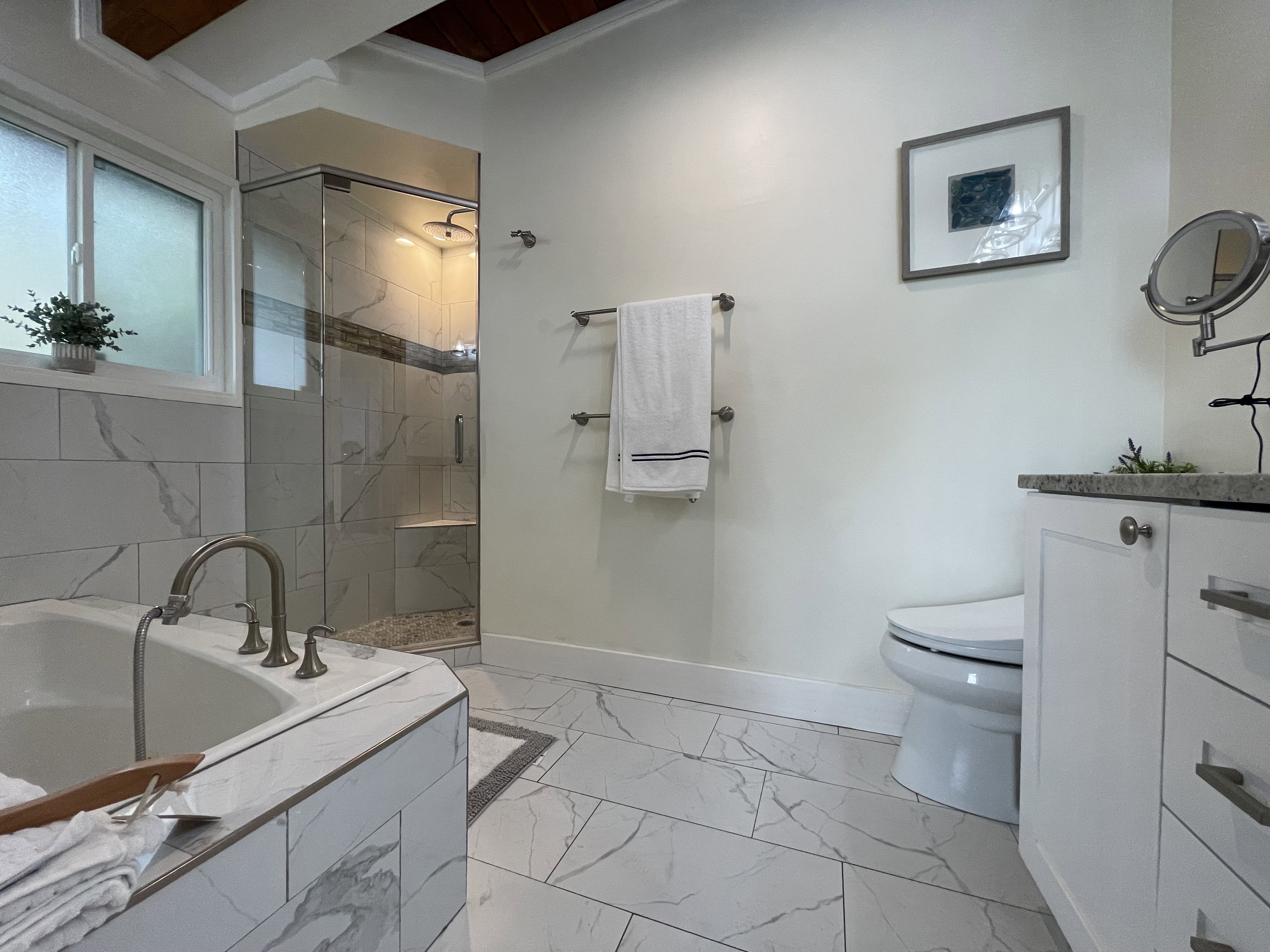 Bathroom featuring a stall shower, vanity, a bath, light marble finish flooring, and ornamental molding
