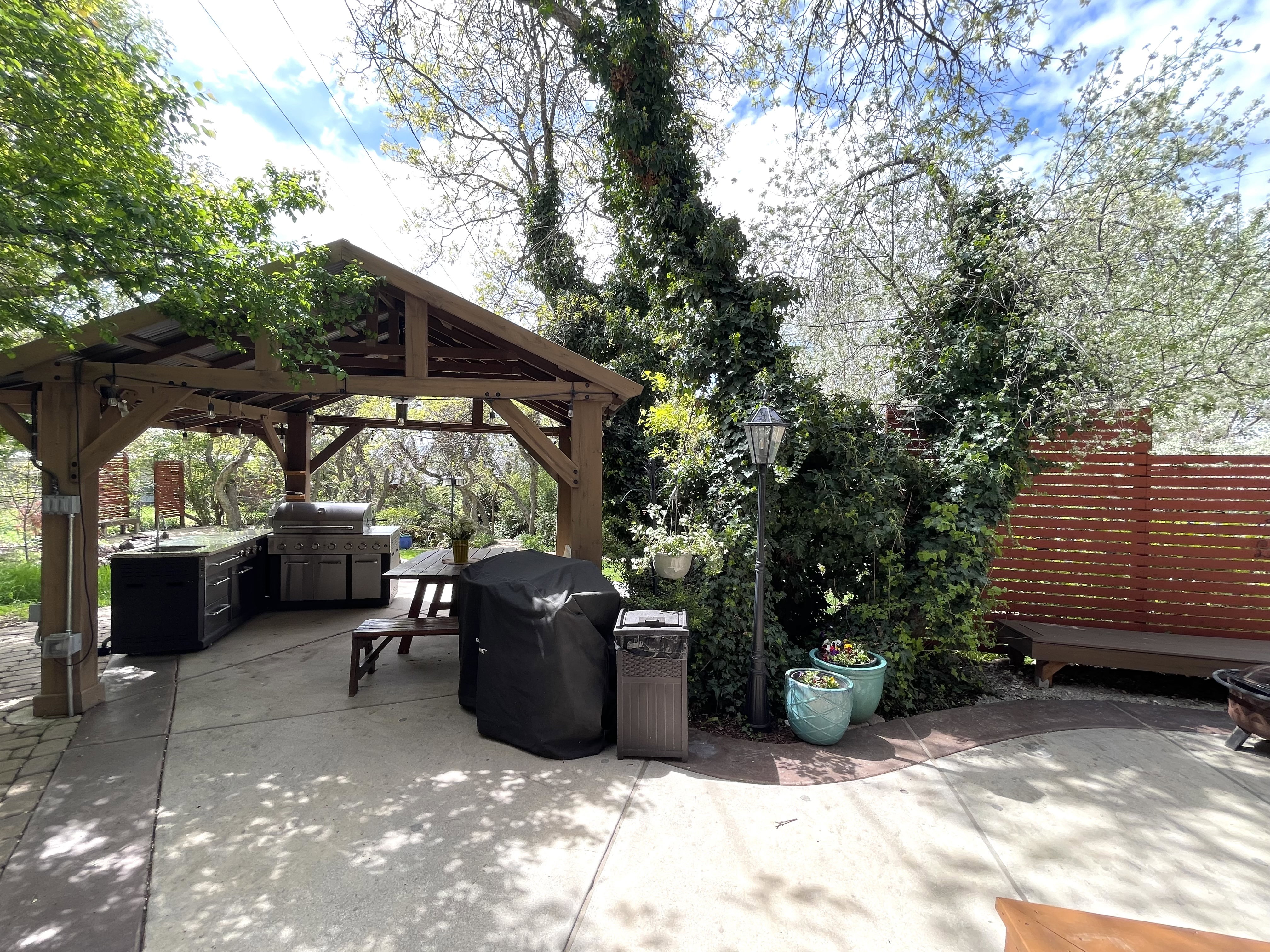 View of patio with a grill