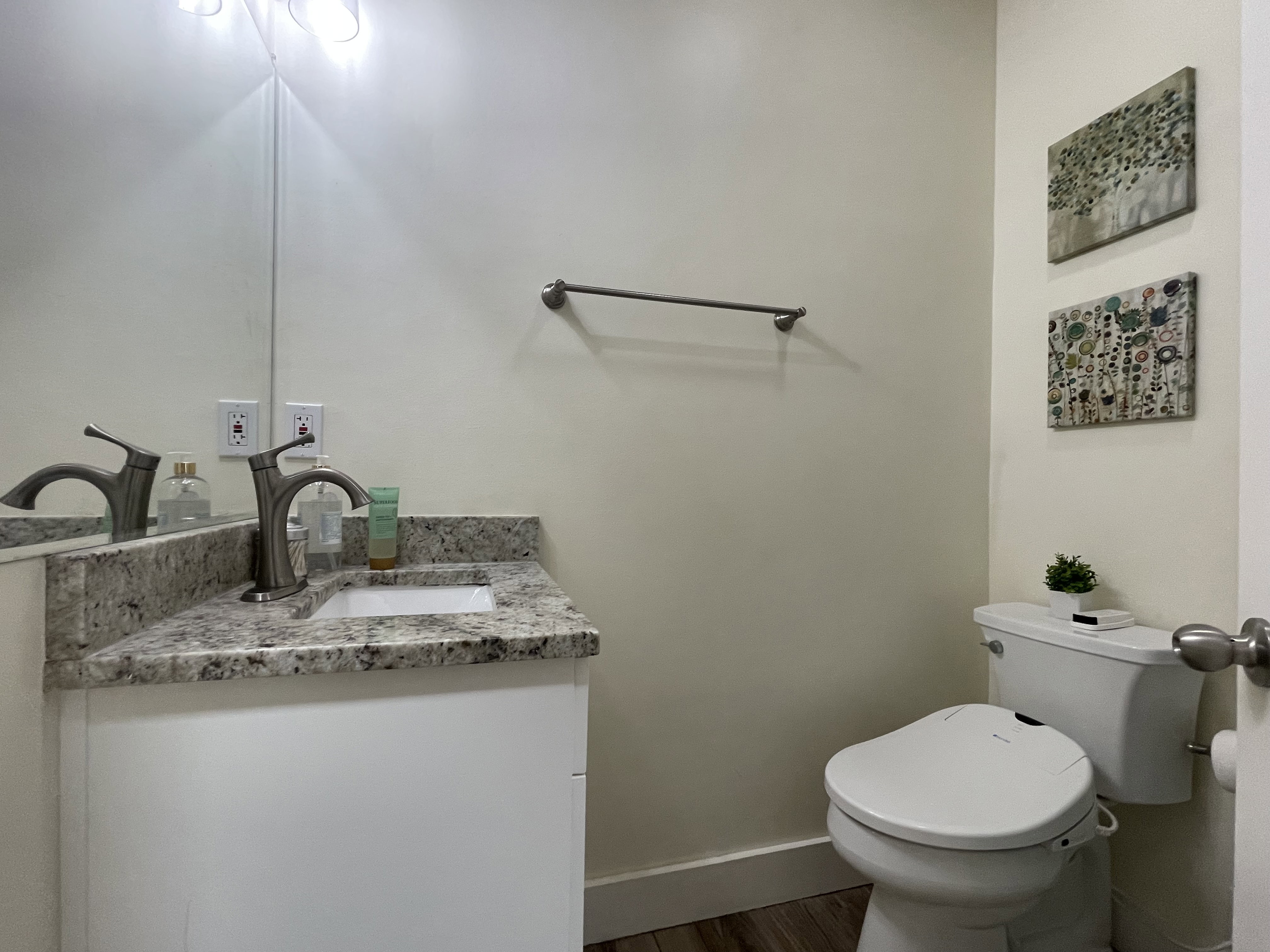 Guest bathroom featuring vanity, a stall shower, and dark wood finished floors
