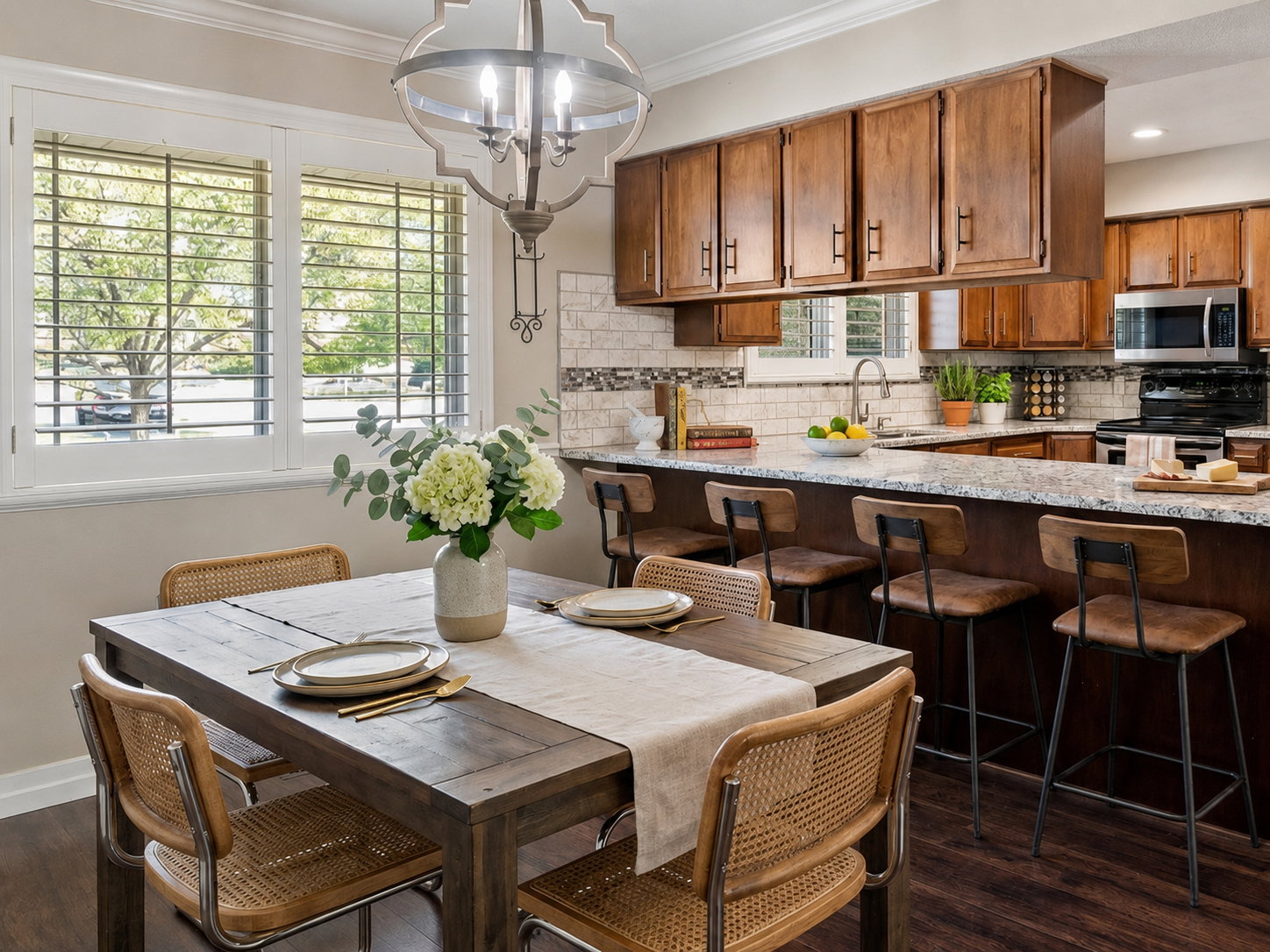 Open-concept dining area featuring a dark wood-finish dining table and wood-finish flooring