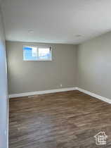 Empty room featuring dark wood finished floors and a textured ceiling