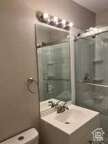 Bathroom with vanity and a stall shower