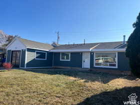 Single story home featuring a front lawn