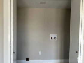 Laundry area with hookup for a washing machine and baseboards