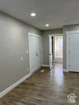 Foyer featuring dark wood finished floors and recessed lighting