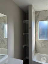 Full bathroom featuring healthy amount of natural light and vanity