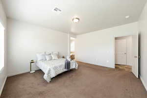 Bedroom with carpet flooring and baseboards