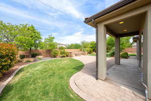Fenced backyard with a patio