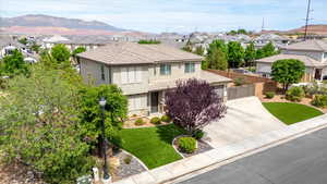 Traditional-style home featuring stucco siding, concrete driveway, a residential view, and an attached garage