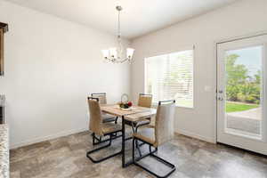 Dining room with stone finish flooring and hanging lights