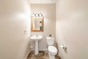 Bathroom with toilet and baseboards