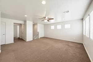 Empty room with recessed lighting, ceiling fan, carpet flooring, and a textured ceiling
