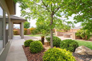 Fenced backyard with a patio and a fire pit