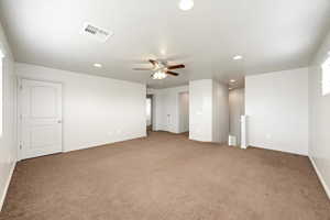 Empty room featuring recessed lighting, ceiling fan, and light colored carpet
