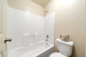 Bathroom featuring shower / bathtub combination and a textured ceiling