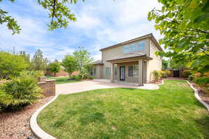 Back of property featuring a fenced backyard, stucco siding, and a patio