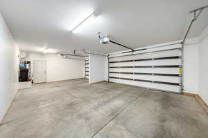 Garage with water heater and a garage door opener