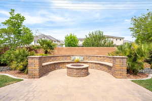 Fenced backyard featuring a fire pit and a patio area