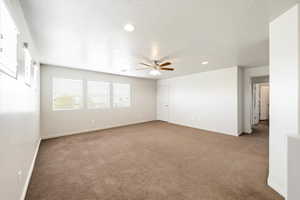 Empty room with recessed lighting, carpet flooring, a ceiling fan, and a textured ceiling