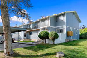 Rear view of house featuring a yard