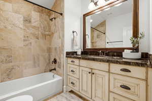 Bathroom with vanity and shower / bath combination