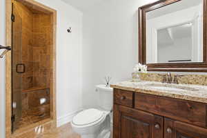 Bathroom with a stall shower, vanity, and light tile patterned flooring