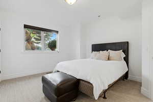 Bedroom with light colored carpet