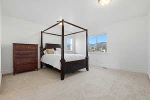 Bedroom with a mountain view and light carpet