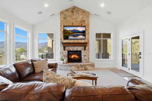 Living area featuring a high ceiling and a fireplace
