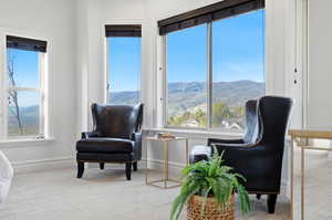 Sitting room with light colored carpet and a mountain view