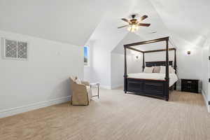 Bedroom featuring light colored carpet, a ceiling fan, and vaulted ceiling