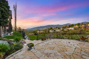 Patio terrace at dusk featuring a mountain view, a residential view, and a patio area