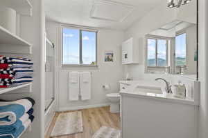 Primary bathroom featuring vanity, and enclosed tub / shower combo